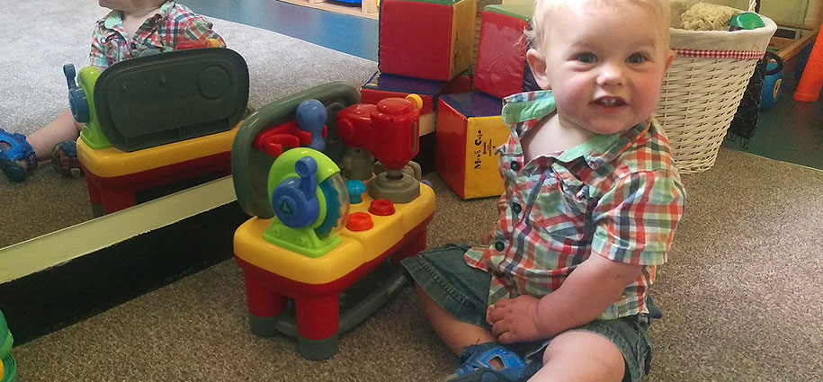 Radbrook Nursery home image 1 Baby playing with toys